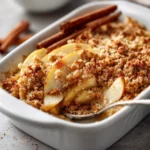 Gluten free apple crisp baked with almond flour and oats served warm with ice cream